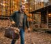 a man carrying woods in leather wood carrier