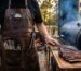 a person grilling bbq and displaying Best Leather BBQ Aprons for Pitmasters
