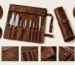 Brown leather knife roll with multiple compartments and buckle closure